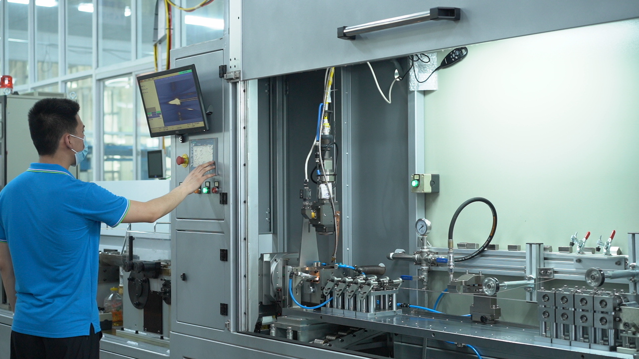 Ebocom technician operating cable production equipment